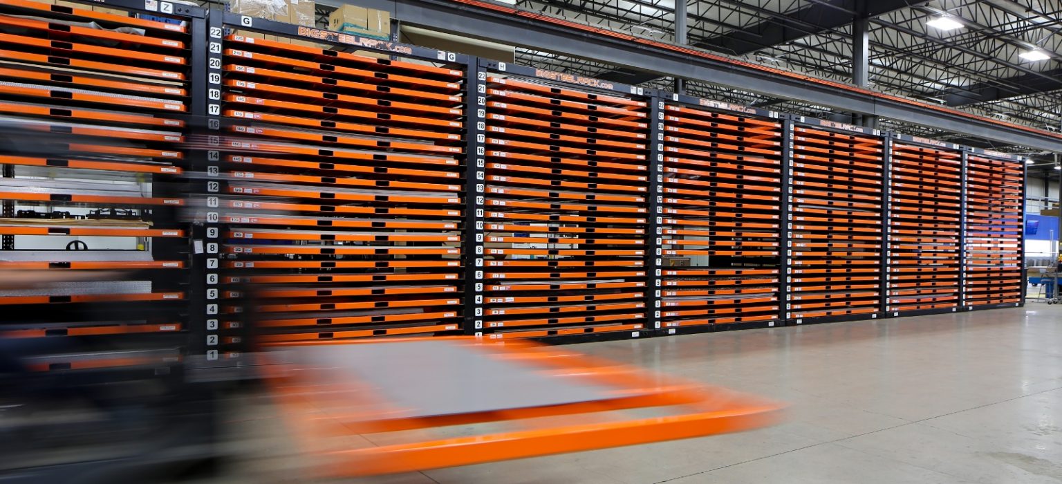 forklift moving sheet metal through warehouse